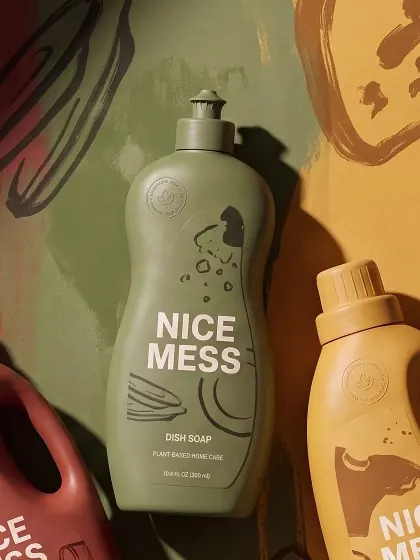 Dish Soap bottle lying on an olive painted backdrop