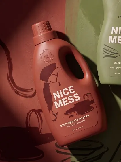 Multi-Surface Cleaner lying on a painted terracotta and olive backdrop
